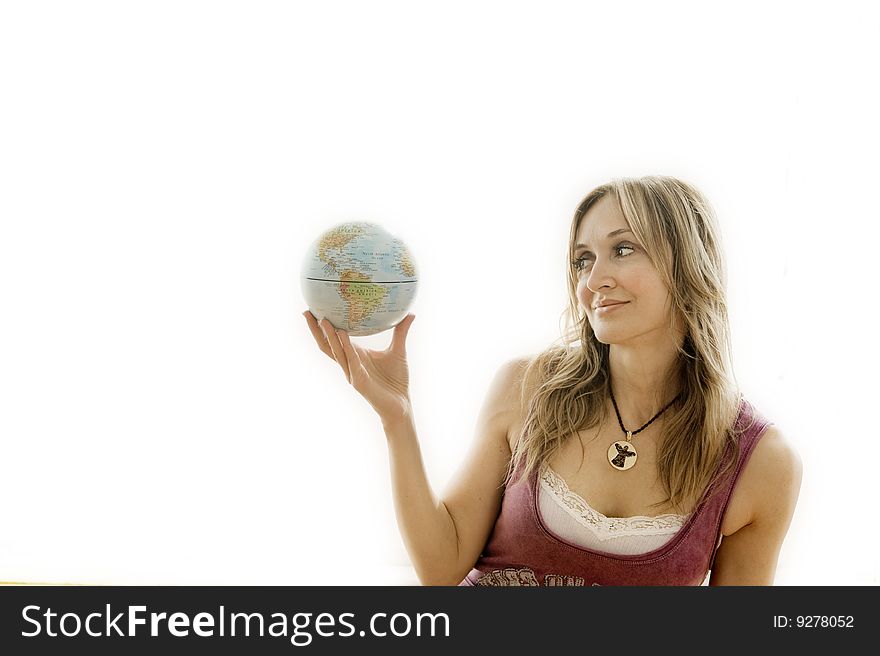 Young woman holding a small globe in her hand. Young woman holding a small globe in her hand.
