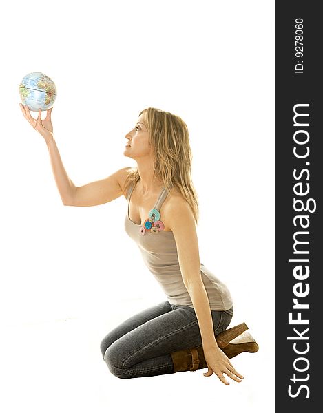 Young woman holding a small globe in her hand. Young woman holding a small globe in her hand.