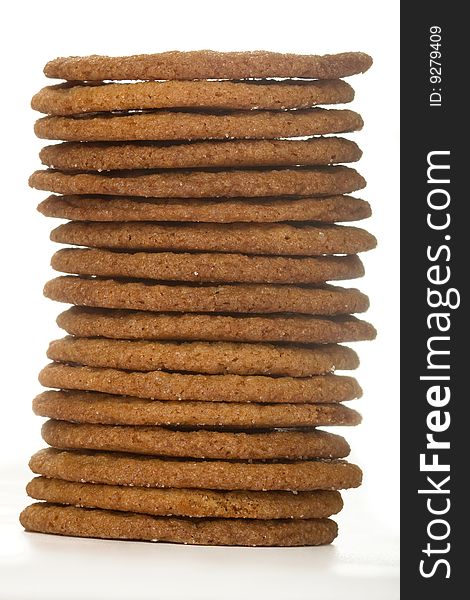 Stacked thin ginger wafer ccokies on white. Stacked thin ginger wafer ccokies on white