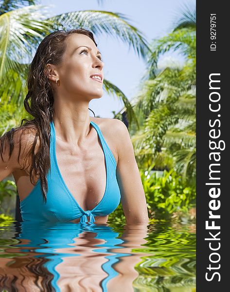 Portrait of young attractive woman having good time swimming pool. Portrait of young attractive woman having good time swimming pool