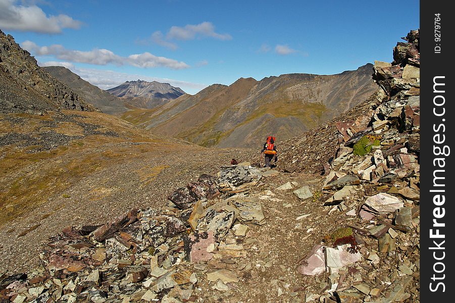 A lone backpacker hikes the trail to Grizzly Lake in central Yukon Territory, Canada. A lone backpacker hikes the trail to Grizzly Lake in central Yukon Territory, Canada