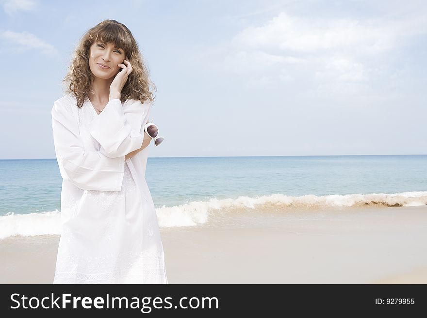 Portrait of nice young woman having good time on the beach. Portrait of nice young woman having good time on the beach