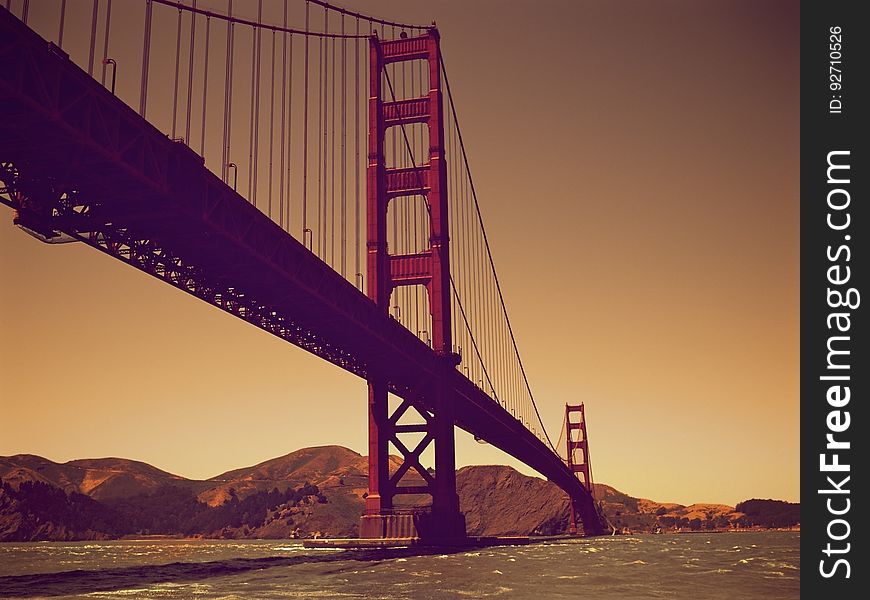 Scenic underside view of Golden Gate bridge at sunset. California, USA.