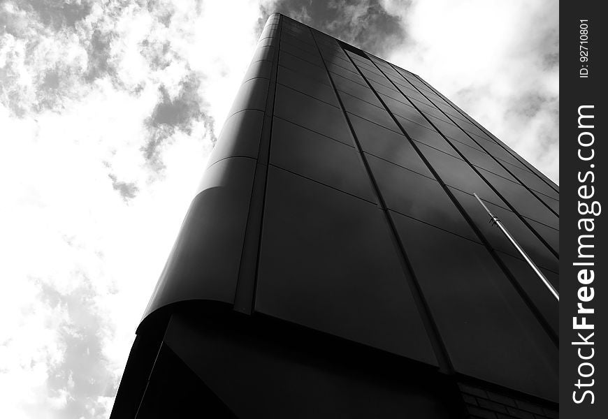 Upward view from the base of a modern black high rise. Upward view from the base of a modern black high rise.