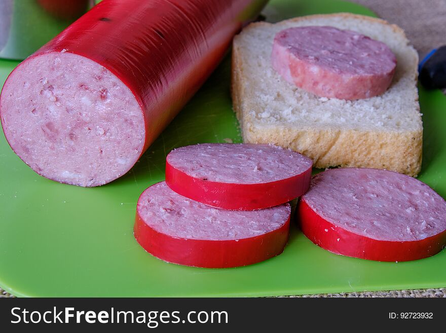 Homemade sausage on a plastic Board and bread