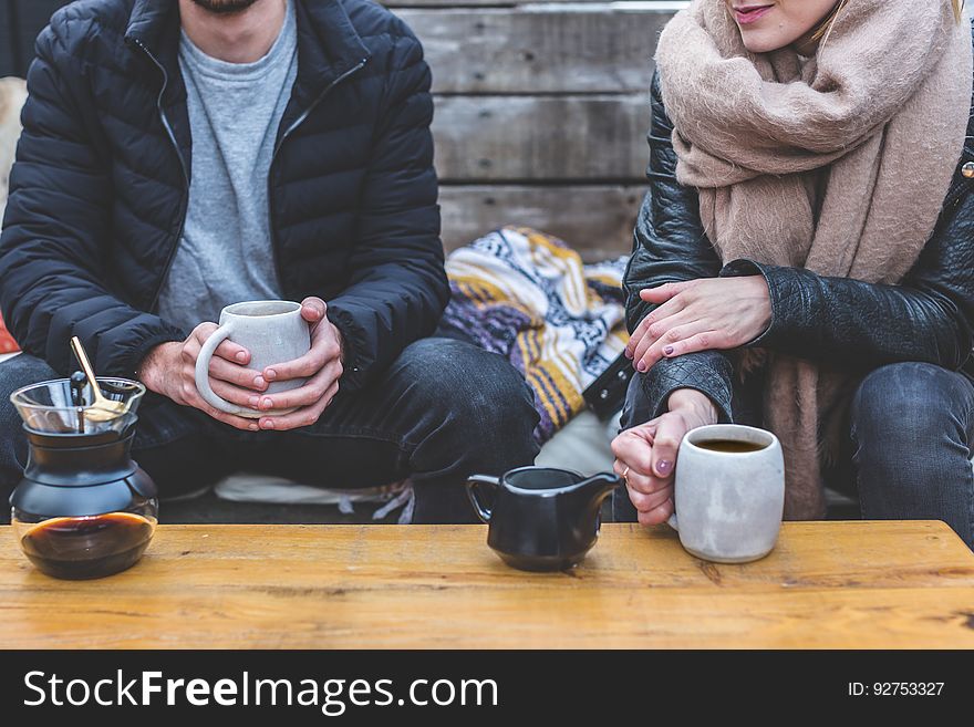 Man And Woman Having Coffee Outdoors