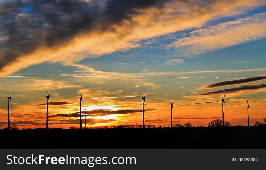 Wind turbines silhouetted by the setting sun. Wind turbines silhouetted by the setting sun.