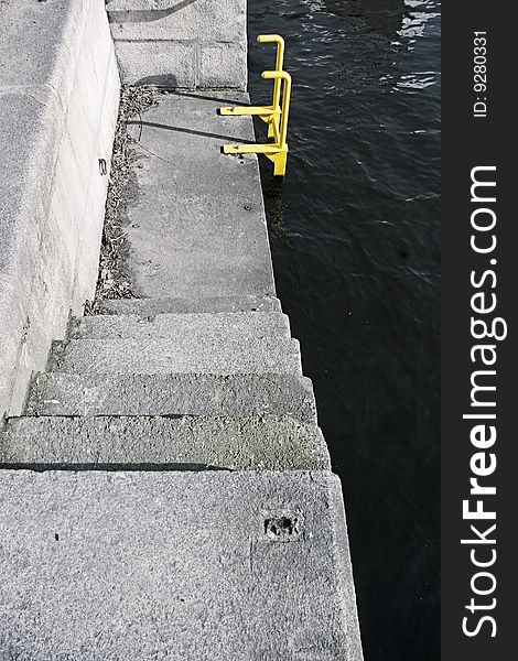 Steps at a pier and a yellow ladder. Steps at a pier and a yellow ladder