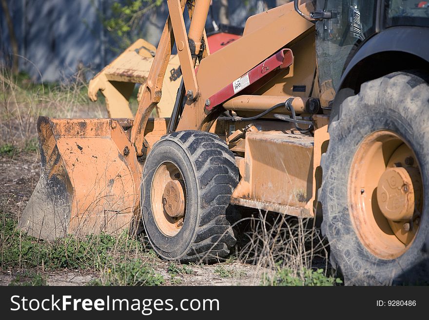 Loader close up on site in grass field