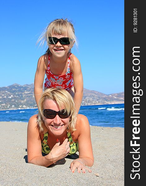 Happy mum with a daughter have a rest on the sea