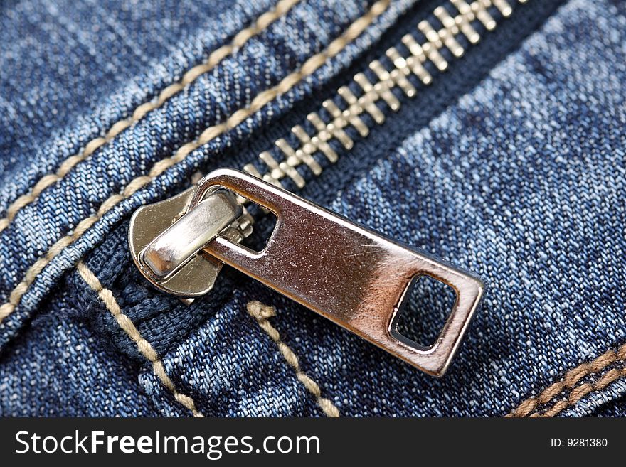 Closeup of the zipper of a stylish blue jeans