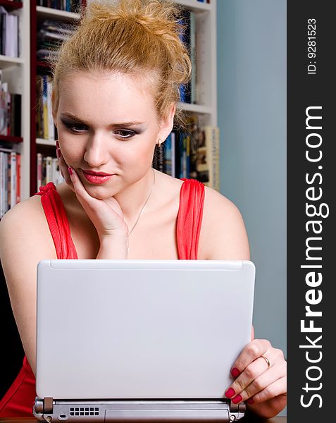 Funny attractive woman with computer indoors. Funny attractive woman with computer indoors