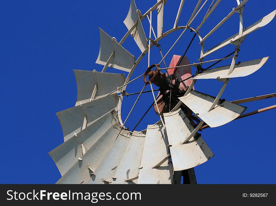 Close up of a windmill with a clear blue sky