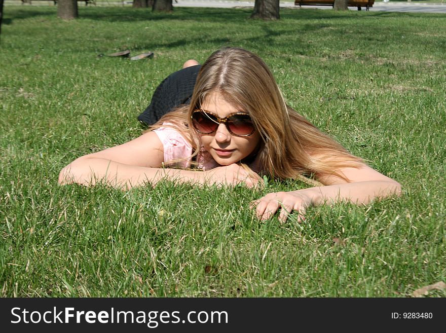 Girl lying on grass in a park