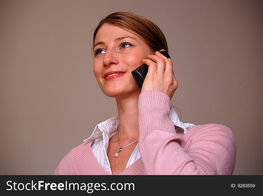Young attractive woman at the phone. Young attractive woman at the phone