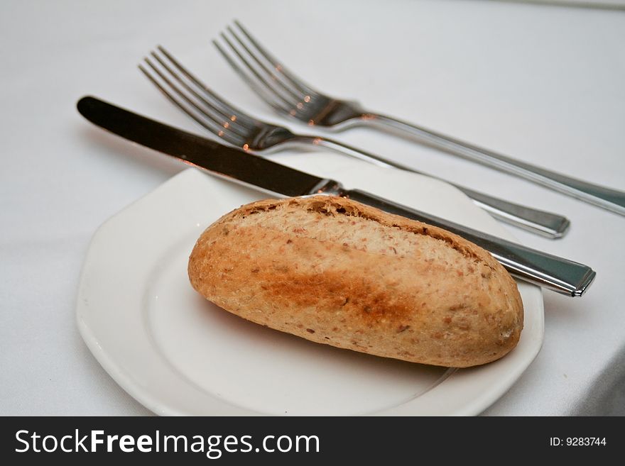 Bread on a plate with cutlery. Bread on a plate with cutlery