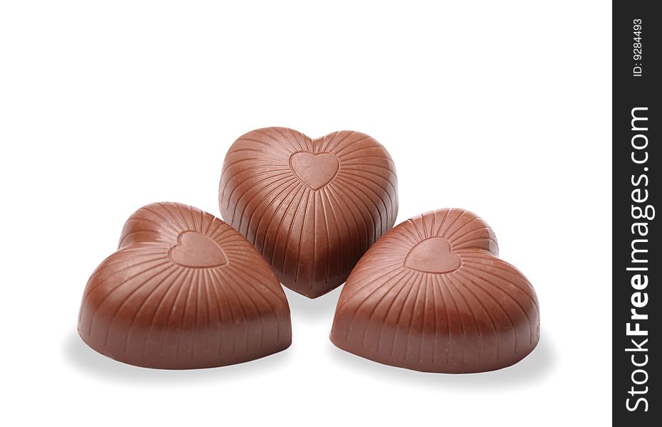 Three chocolate hearts on the white background. Three chocolate hearts on the white background