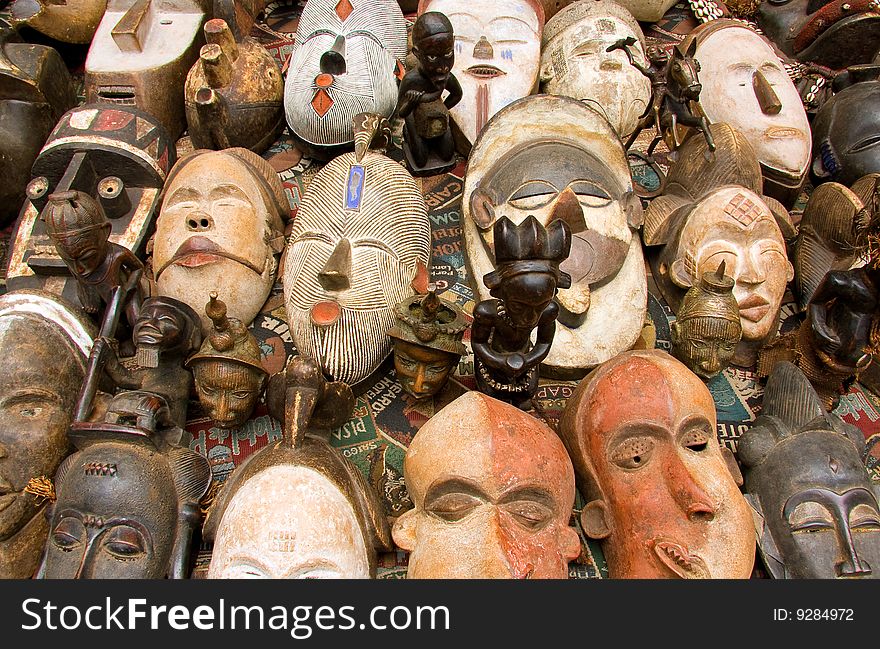 A variety of ancient mask on a table. A variety of ancient mask on a table.