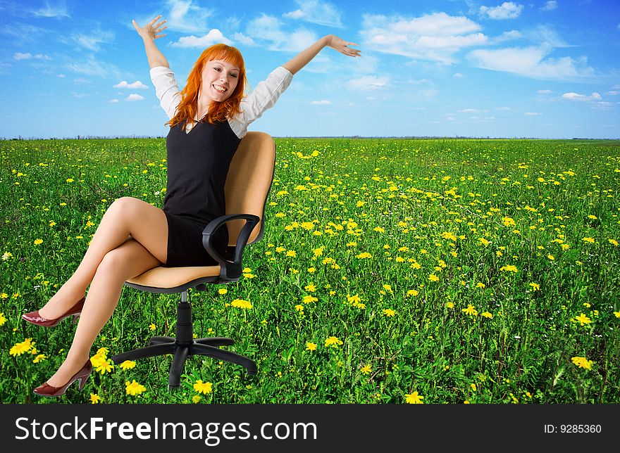 Cheerful businesswoman on a beautiful meadow full of flowers