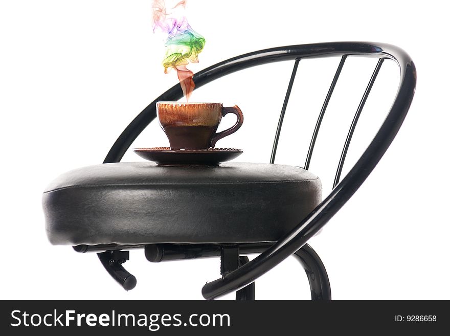 Coffee cup on a bar chair with a colour smoke. Isolated over white. Coffee cup on a bar chair with a colour smoke. Isolated over white.