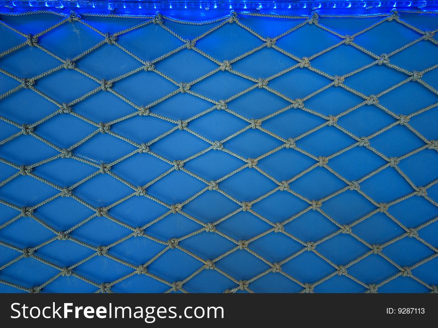 Fishing net on a blue background. Fishing net on a blue background