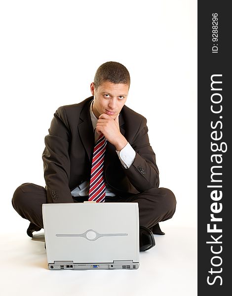 Businessman sitting on the floor in front of his laptop. Businessman sitting on the floor in front of his laptop
