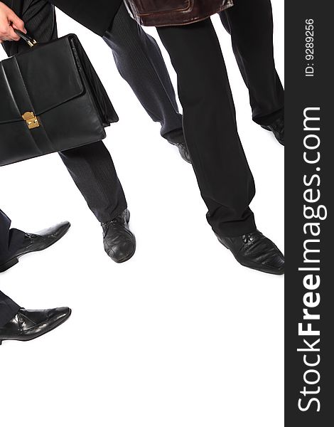 Legs of businessmen and  briefcase in hand on white