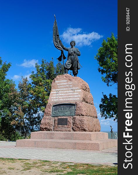 Monument to the Cossack with a banner against the sky. Monument to the Cossack with a banner against the sky