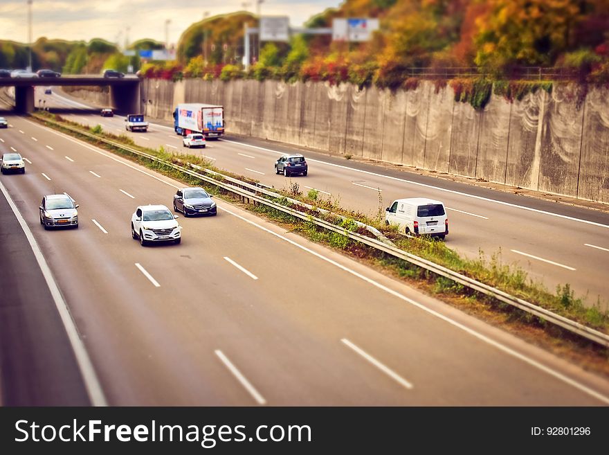 A six-lane freeway with cars on it. A six-lane freeway with cars on it.