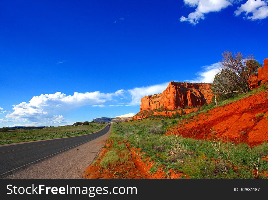 A road passing by red rocks in Arizona.