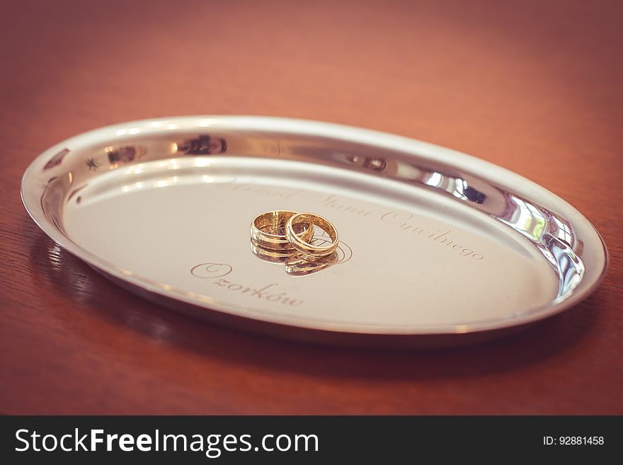 A pair of wedding rings on a silver plate. A pair of wedding rings on a silver plate.