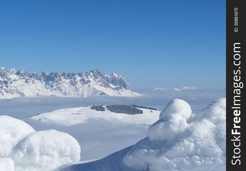 Scenic View Of Snow Mountains Against Blue Sky