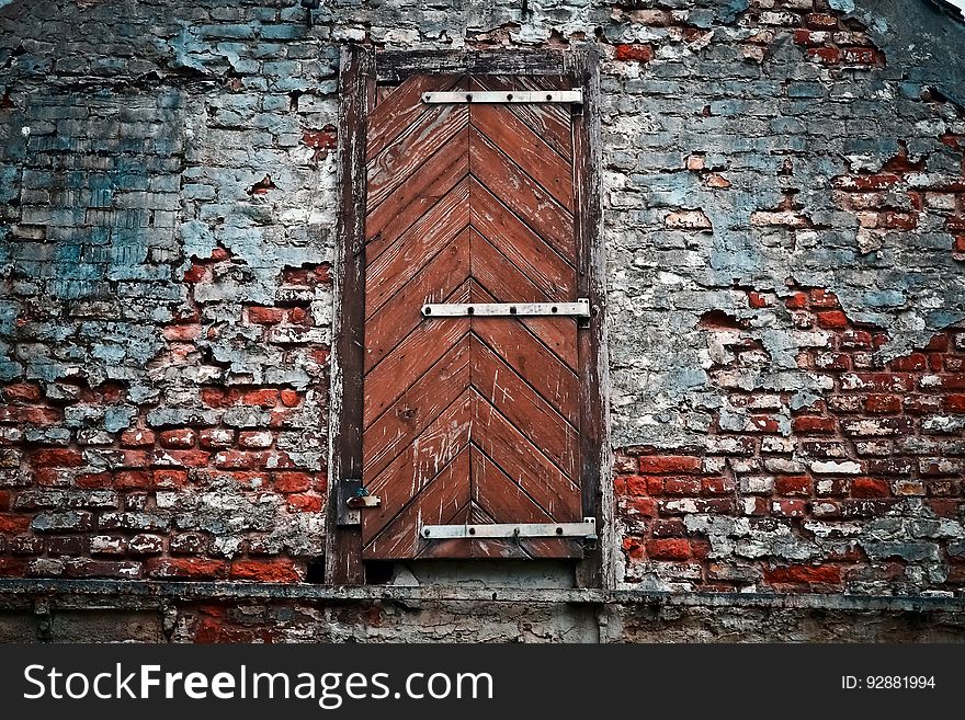 An old door in a weathered brick wall. An old door in a weathered brick wall.