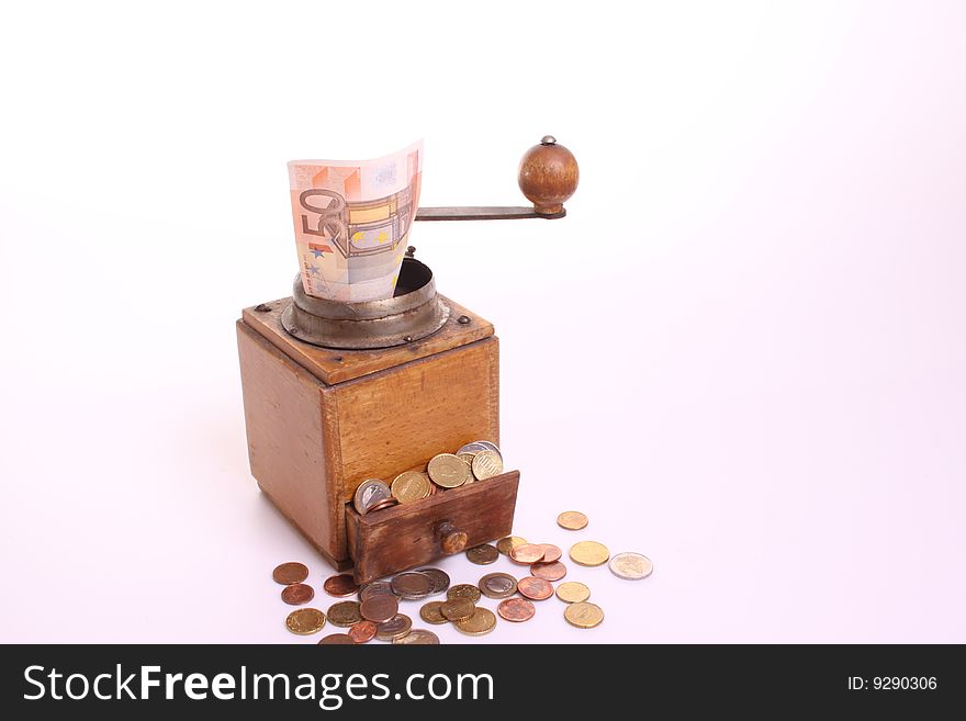 Coffee-grinder converts banknote into coins against a white isolated background wit copy-space