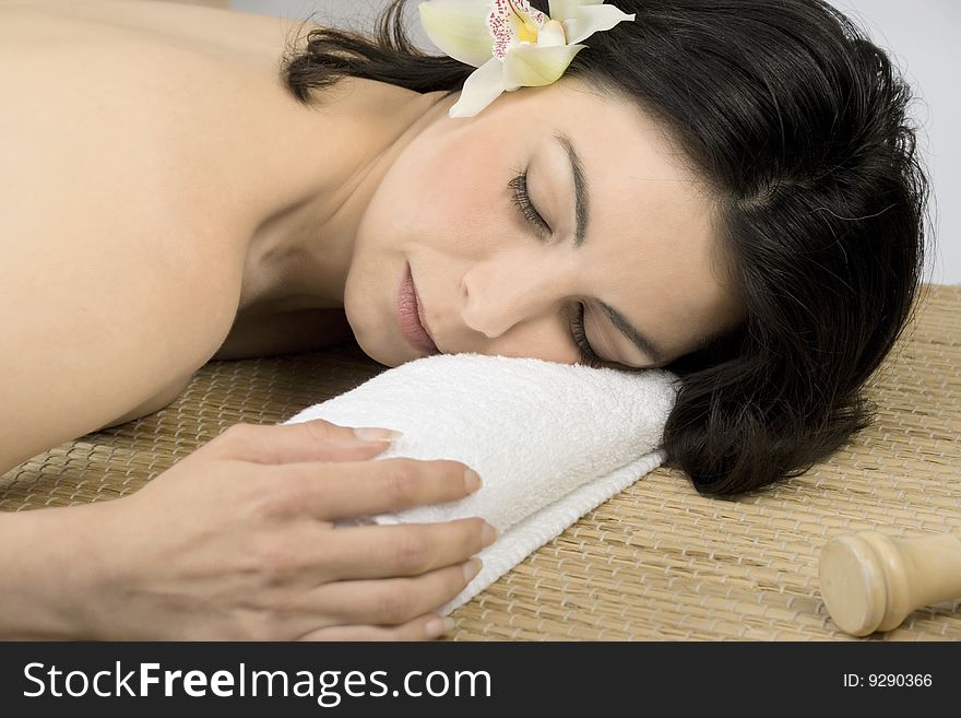 Young attractive  woman relaxing on the massage bed