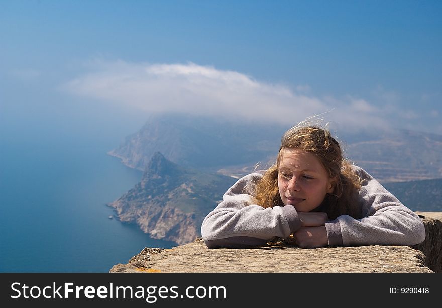 The young woman has a rest against a sea landscape. The young woman has a rest against a sea landscape