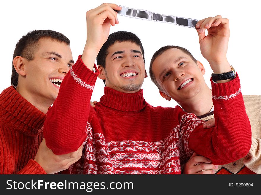 Three friends look at film on white. Three friends look at film on white