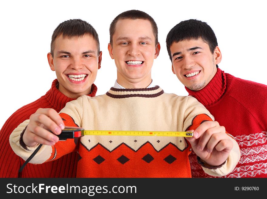 Three young men with tape measure on white