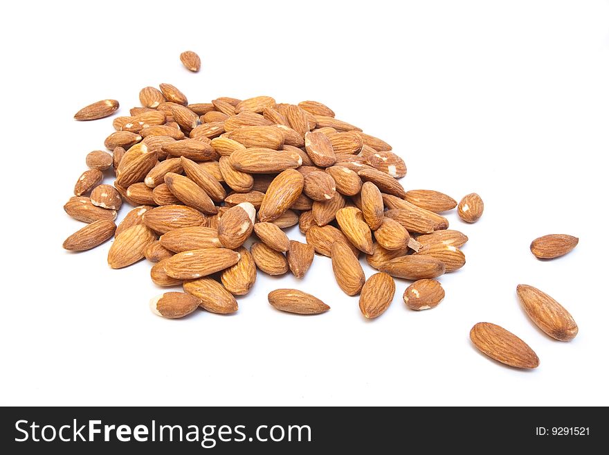 Heap of almonds isolated on white with dof effect. Heap of almonds isolated on white with dof effect