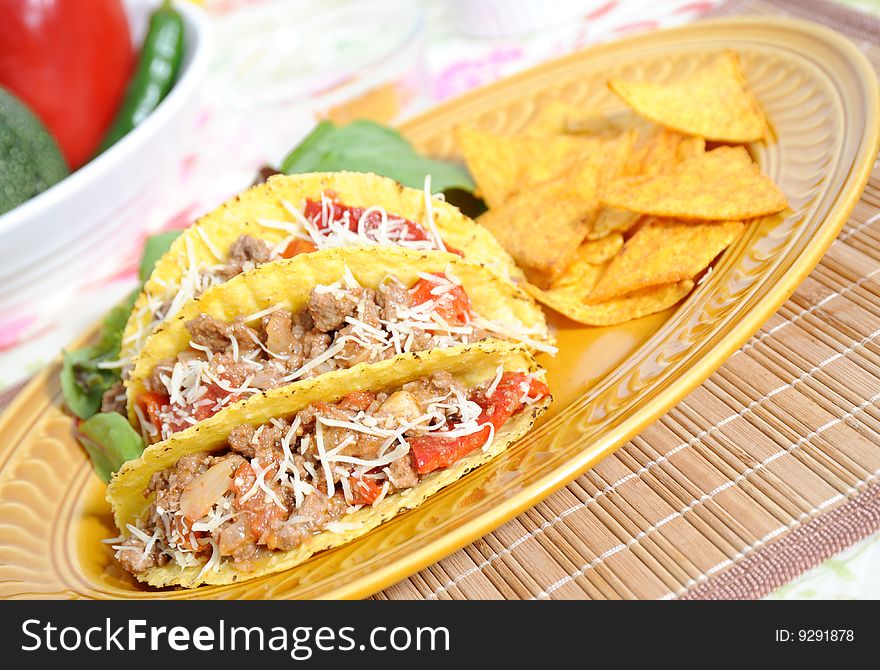 Tacos filled with minced meat peppers and cheese - salad and tortillas on side. Tacos filled with minced meat peppers and cheese - salad and tortillas on side