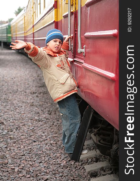 Little Boy on footboard of passenger wagon