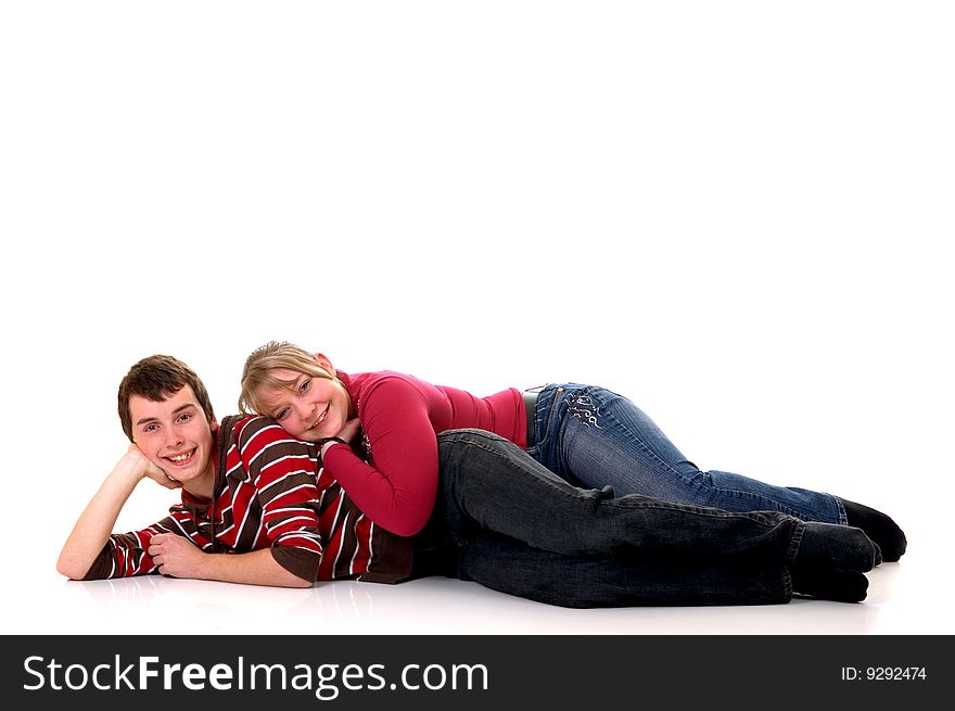 Two casual dressed teenagers, teenage man and woman in love, studio shot, reflective surface. Two casual dressed teenagers, teenage man and woman in love, studio shot, reflective surface