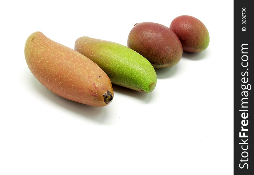 Raw and green  mangoes isolated over white background.