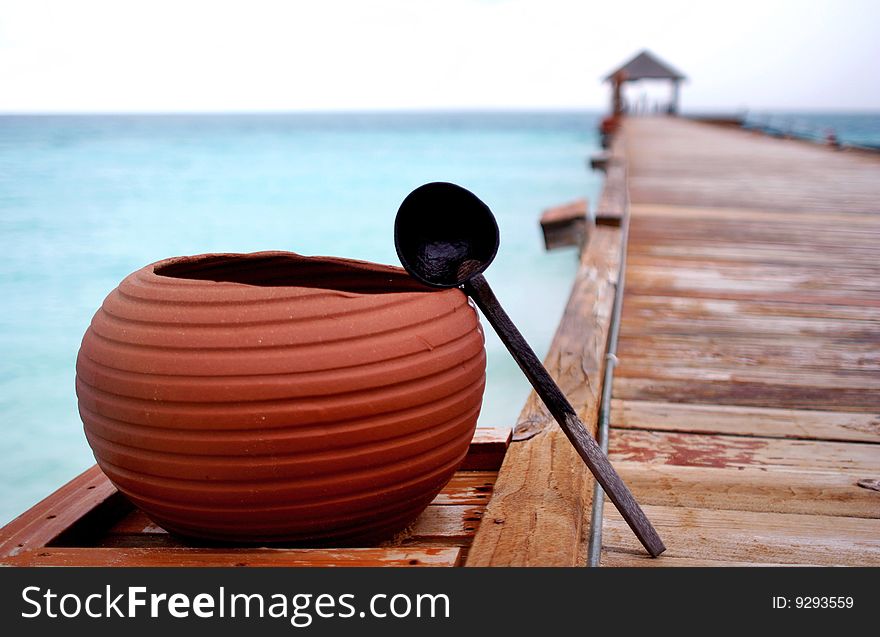 A pot at the side of a footbridge of a exotic resort at Maldives. A pot at the side of a footbridge of a exotic resort at Maldives.