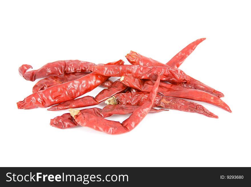 Dried red hot chili peppers on a white background.