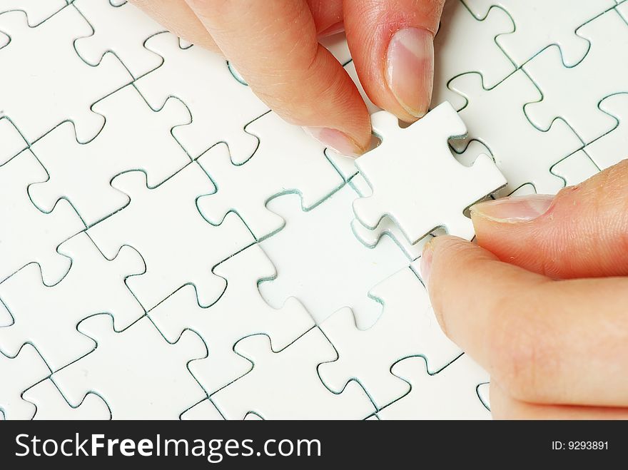 Hands holding a puzzle piece . business concepts