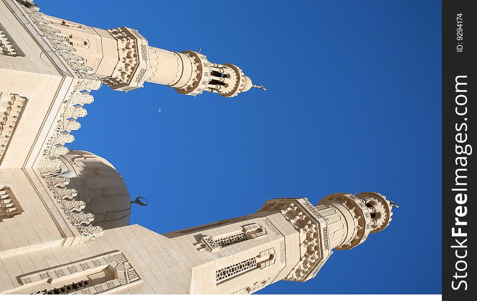 Domes of a minaret with a half moon against the blue sky. Domes of a minaret with a half moon against the blue sky