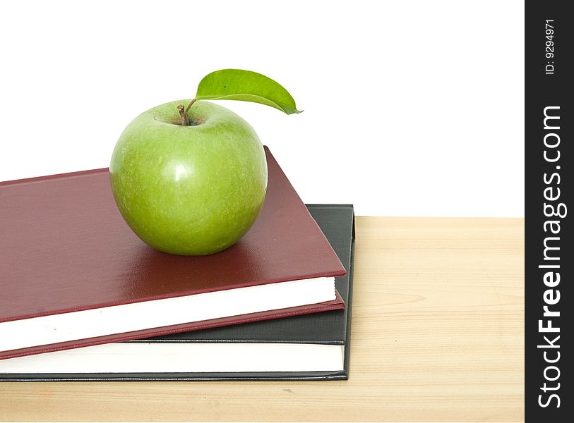 Close up of green apple on books