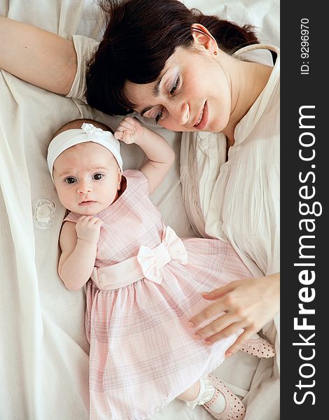 Happy mother lying with her newborn daughter. Happy mother lying with her newborn daughter