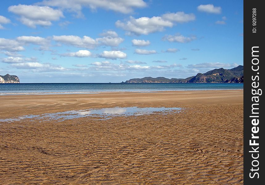 Whangapoua Beach at Low Tide, Great Barrier Island, New Zealand. Whangapoua Beach at Low Tide, Great Barrier Island, New Zealand